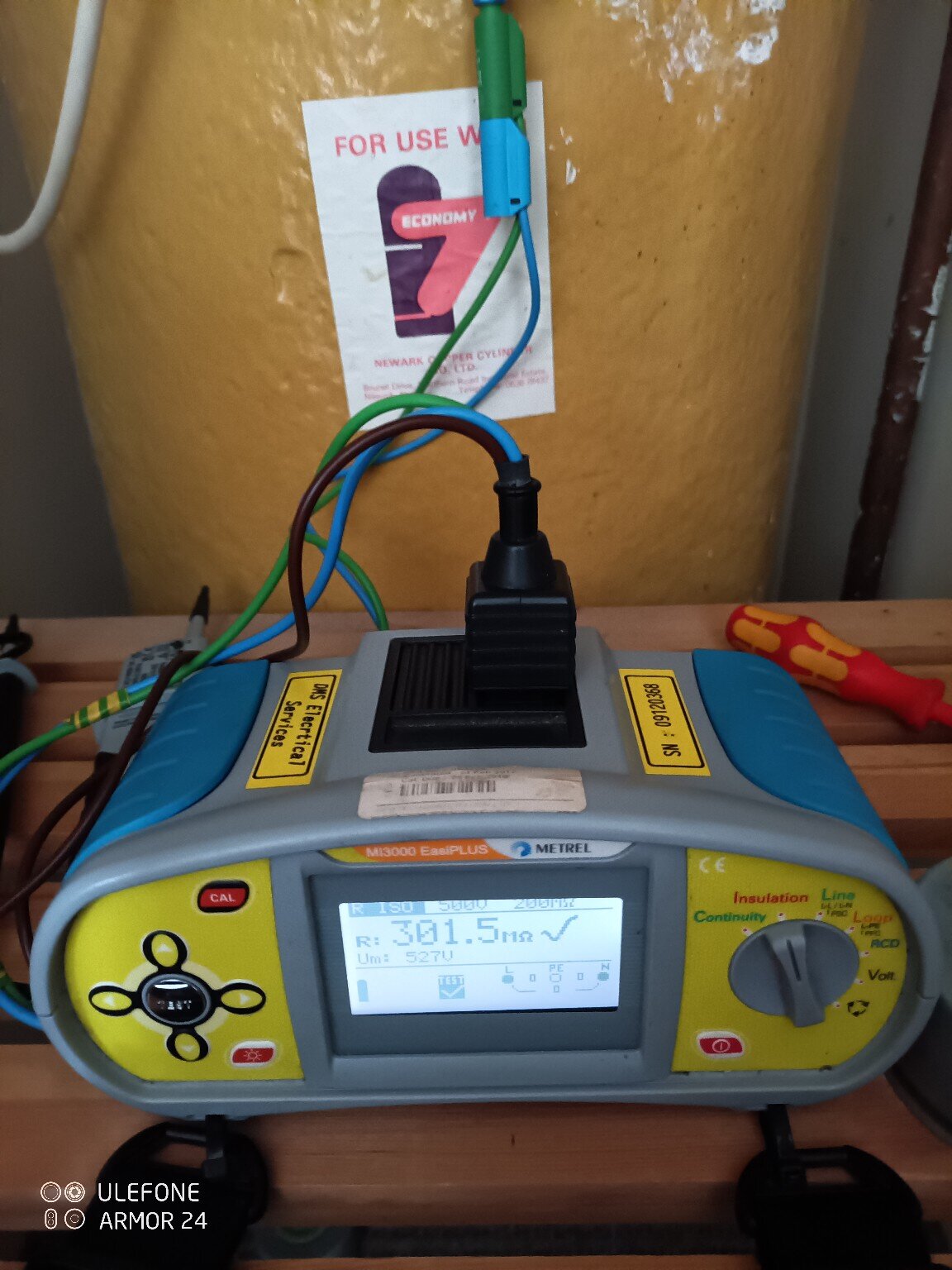 Professional multifunction electrical tester connected during insulation resistance testing in a domestic property