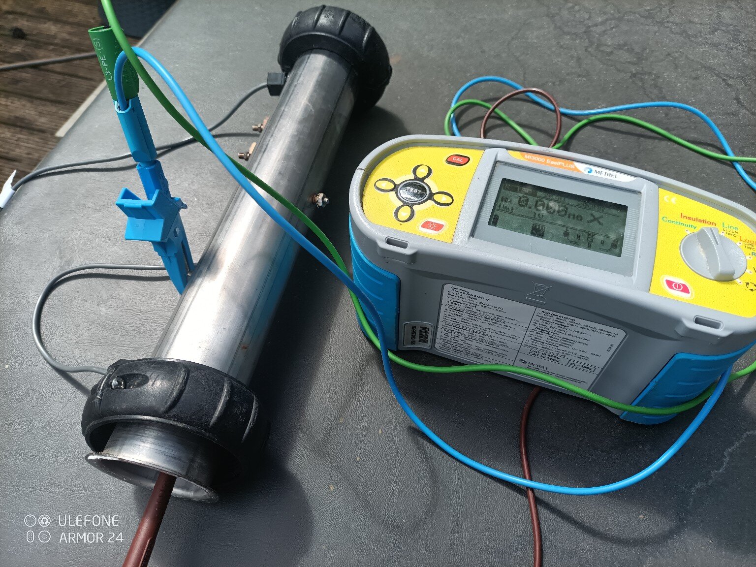 Multifunction electrical tester connected to a hot-tub heater assembly during electrical diagnosis