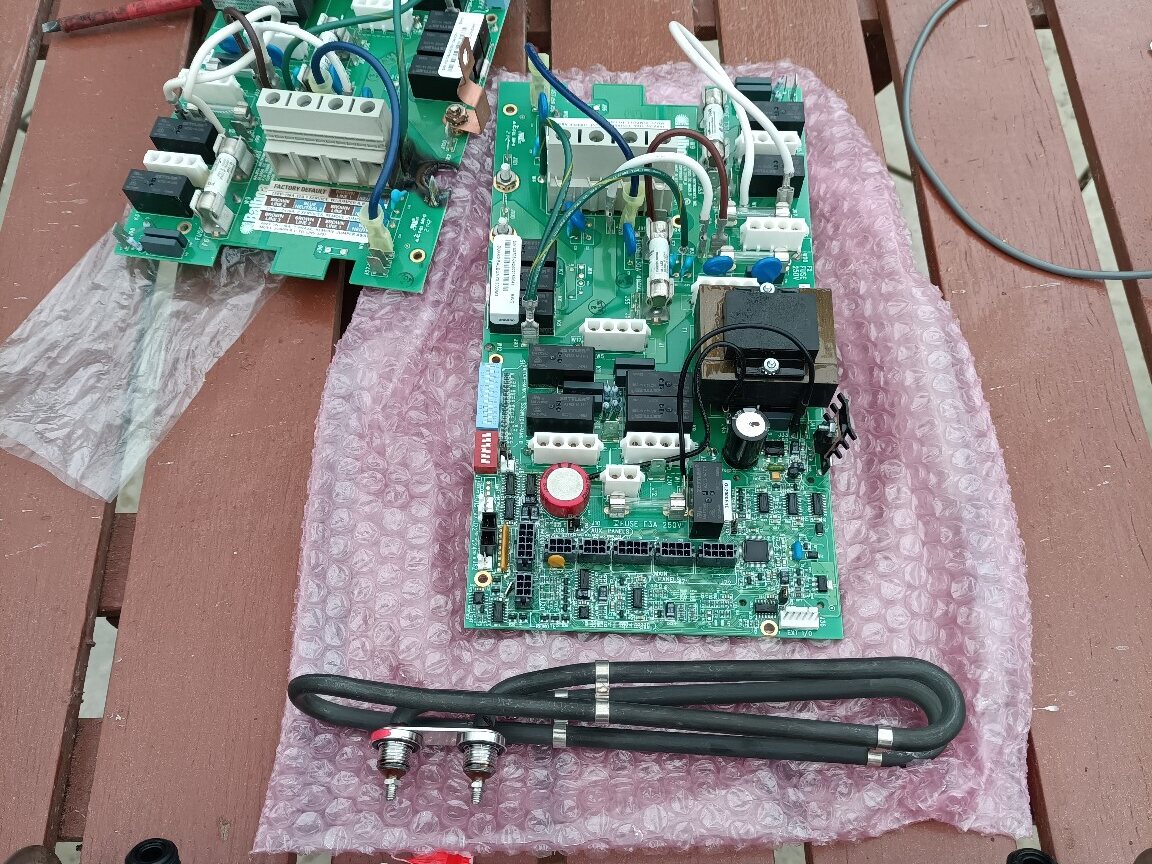 Replacement hot-tub circuit board and heater element prepared beside the removed components