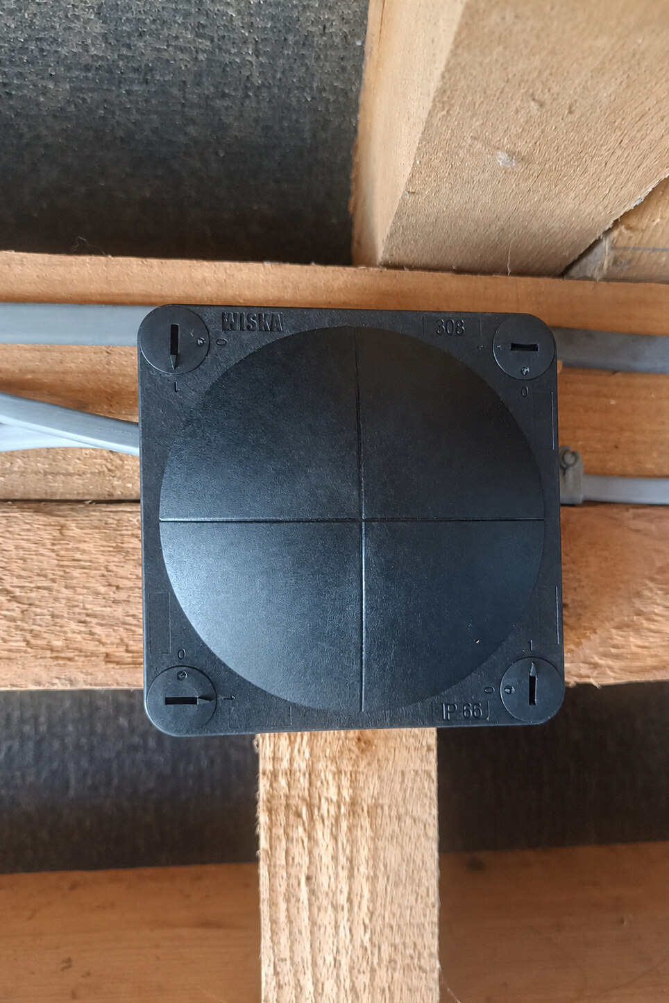 Completed remedial work with the lighting connections enclosed inside a closed black Wiska junction box